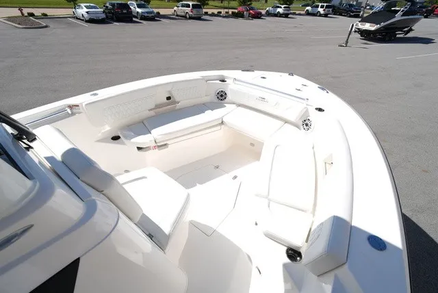 Slide: The Image of Cobia 245 Center Console 2027: Spacious bow area with cushioned seating and speakers. - 27