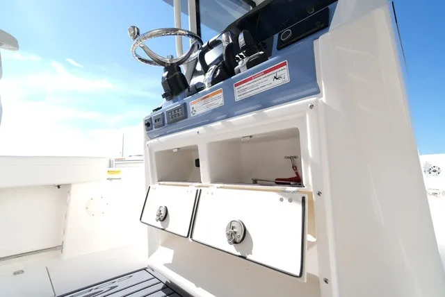 Slide: The Image of Cobia 245 Center Console 2027: Helm station with steering wheel, instruments, and storage compartments. - 22