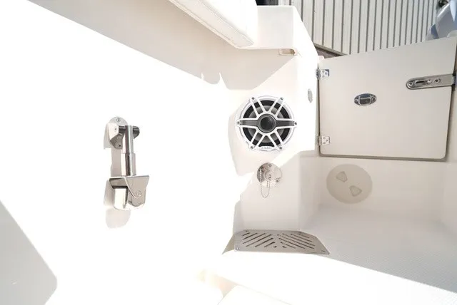 Slide: The Image of Cobia 245 Center Console 2027: Close-up of cockpit with speaker and stainless steel fittings. - 16