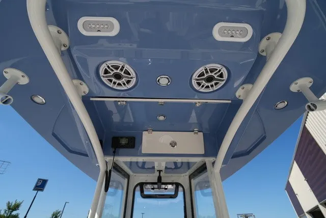 Slide: The Image of Cobia 245 Center Console 2027: View of the blue T-top with speakers and lights. - 20