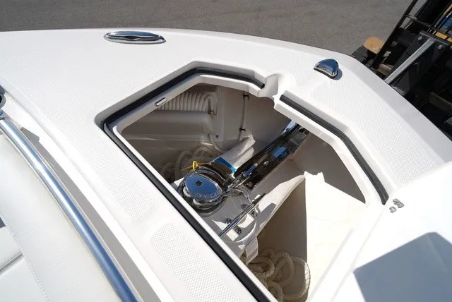 Slide: The Image of The 2027 Cobia 245 Center Console features an open anchor locker with ropes and a windlass. - 33