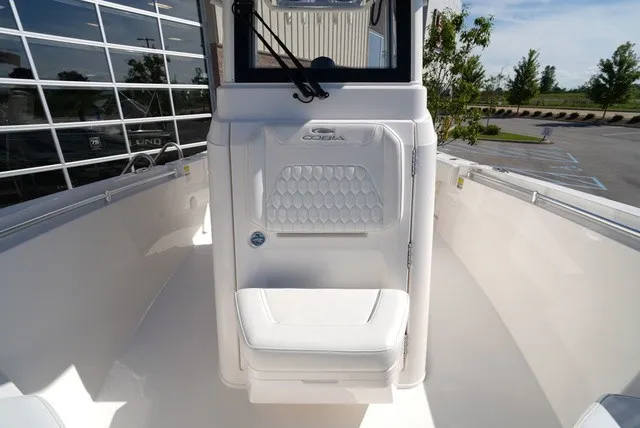 Slide: The Image of The 2027 Cobia 245 Center Console features a clean, white seat in front of the helm console. - 30