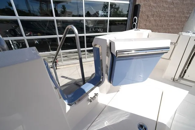 Slide: The Image of The image shows the stern of a Cobia 245 Center Console boat with a blue hatch. - 17