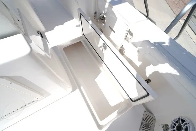 Slide: The Image of The image shows the interior of a 2027 Cobia 245 Center Console boat with an open storage compartment. - 15
