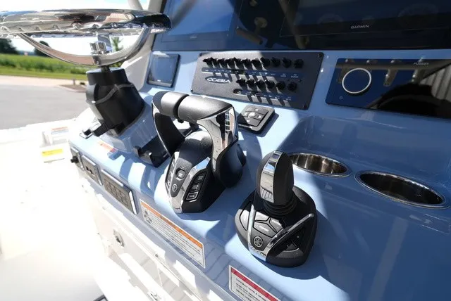 Slide: The Image of The image shows the helm of a Cobia 245 Center Console boat with modern controls. - 23