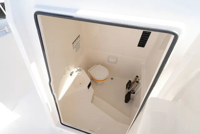 Slide: The Image of Interior view of a boat cabin with a toilet and storage space. - 32