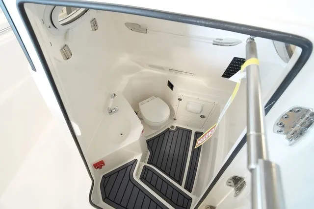 Slide: The Image of Interior view of the 2027 Cobia 265 Center Console with toilet and sink. - 45