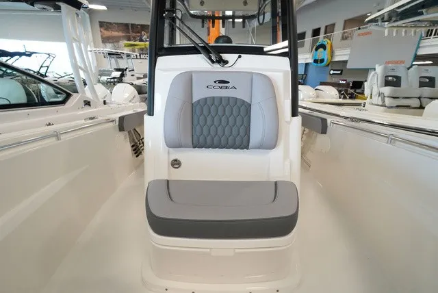 Slide: The Image of The 2027 Cobia 265 Center Console features a stylish bench seat with gray upholstery. - 42