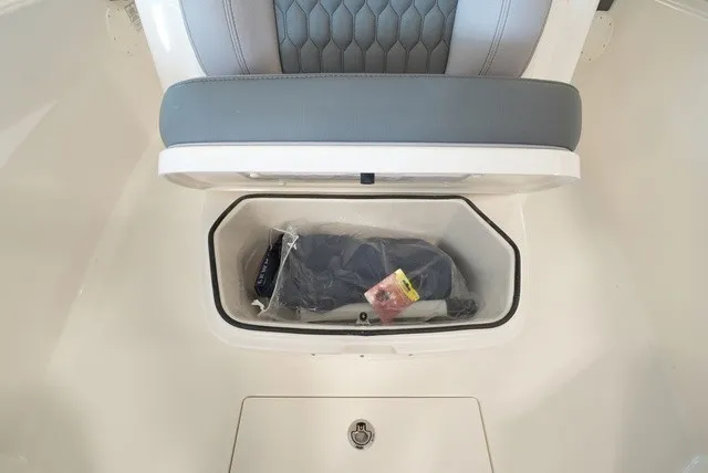 Slide: The Image of Storage compartment under a seat in the Cobia 265 Center Console boat. - 43