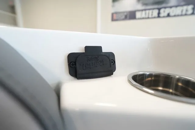 Slide: The Image of Close-up of a cup holder and cover on a Cobia 265 Center Console boat. - 46