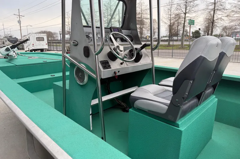 Slide: The Image of Interior of a 2012 Charles Leonard 24 boat with steering console and seating. - 10