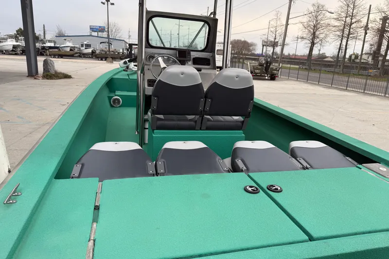 Slide: The Image of Green Charles Leonard 24 boat interior with seating, steering console, and outdoor setting. - 11