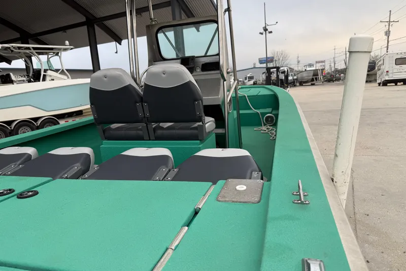 Slide: The Image of Green Charles Leonard 24 boat interior, 2012 model, docked with visible seating and controls. - 12