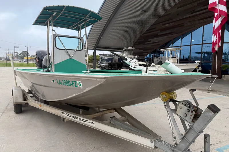 Slide: The Image of Boat on trailer, Charles Leonard model 24, 2012, parked outside with American flag. - 14