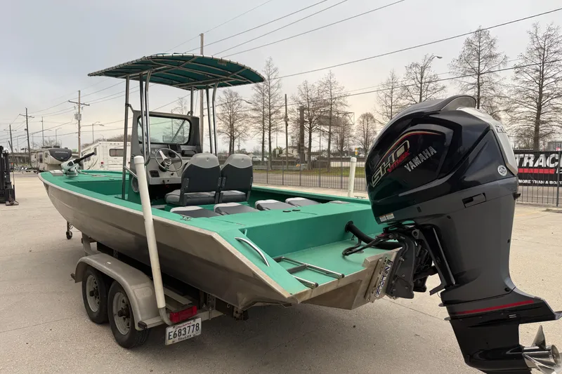 Slide: The Image of Boat on trailer with Yamaha outboard motor, Charles Leonard 24 model, 2012. - 4