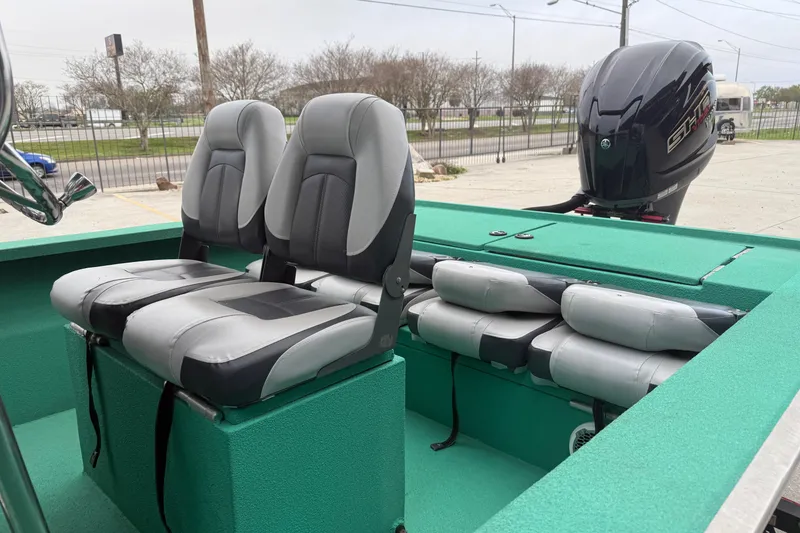 Slide: The Image of Two-tone boat seats on a green deck, featuring a powerful outboard motor. - 8
