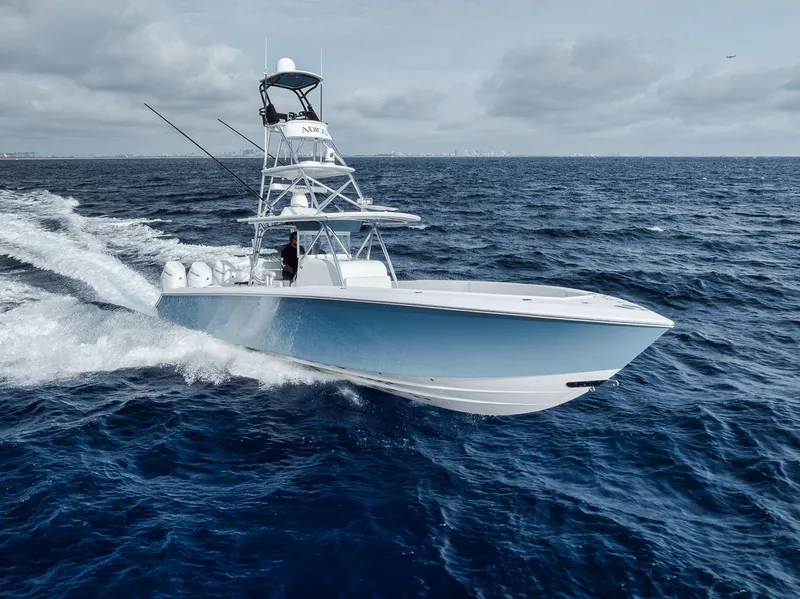 Slide: The Image of Bahama 41 boat cruising on open sea, 2010 model, with clear skies and waves. - 10