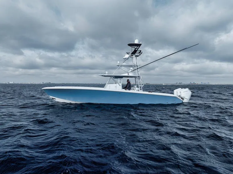 Slide: The Image of 2010 Bahama 41 boat on open water under cloudy skies. - 13