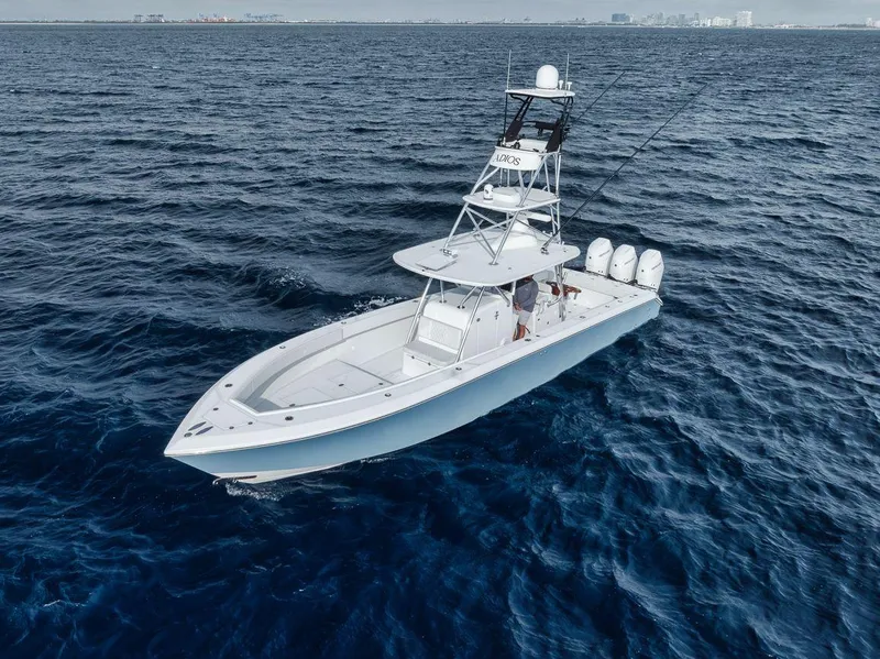 Slide: The Image of 2010 Bahama 41 boat on open ocean, featuring multiple outboard engines. - 15