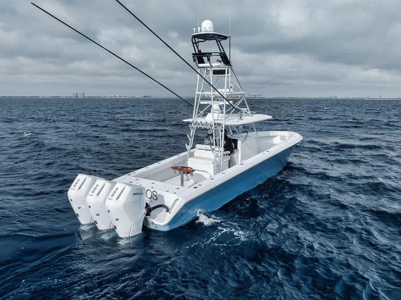 Slide: The Image of 2010 Bahama 41 boat with triple engines on open sea under cloudy sky. - 19