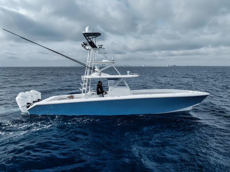 Slide: The Image of 2010 Bahama 41 boat cruising on open ocean under cloudy sky. - 2