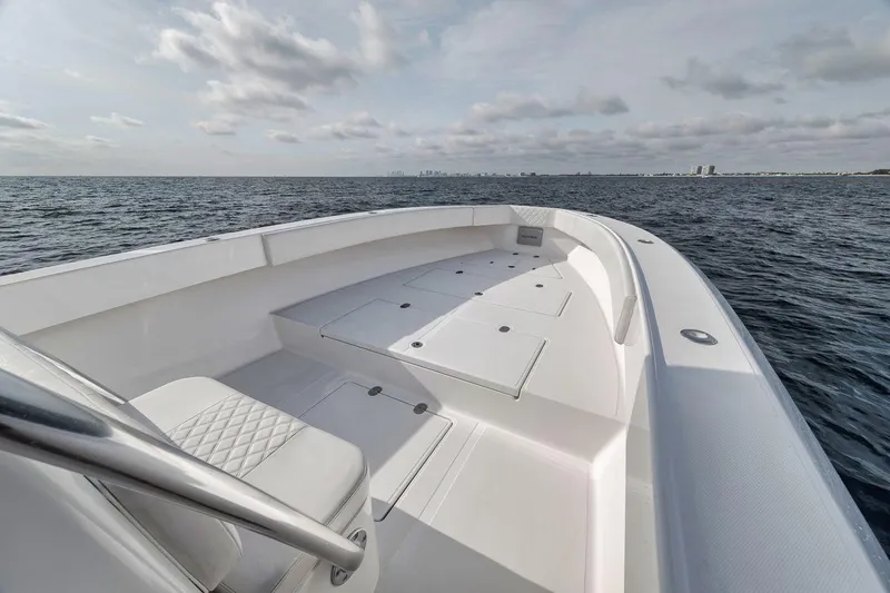 Slide: The Image of 2010 Bahama 41 boat on open water, featuring spacious deck and seating. - 22