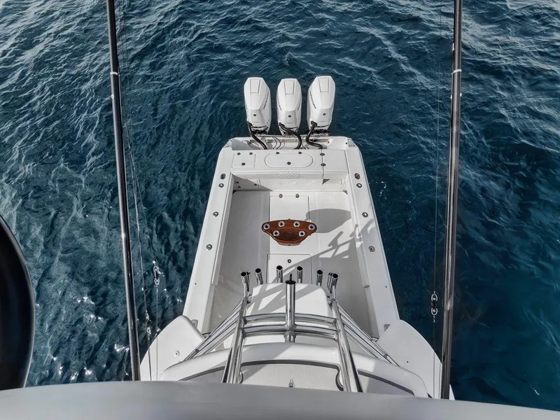 Slide: The Image of Aerial view of 2010 Bahama 41 boat with triple engines on blue water. - 25