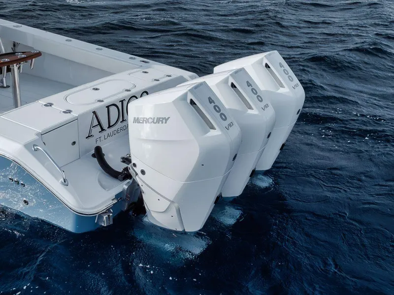 Slide: The Image of 2010 Bahama 41 boat with triple Mercury 600 V12 engines on open water. - 27