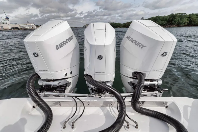 Slide: The Image of Triple Mercury outboard engines on a 2010 Bahama 41 boat, docked on calm water. - 28