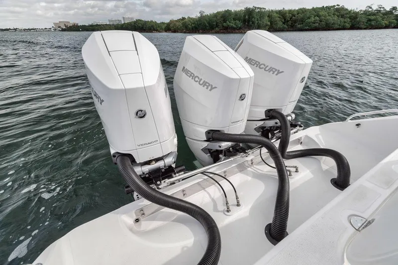 Slide: The Image of Triple Mercury outboard engines on a 2010 Bahama 41 boat in water. - 29