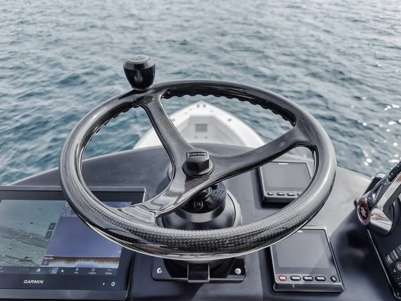 Slide: The Image of Steering wheel of 2010 Bahama 41 boat with navigation equipment on open water. - 33