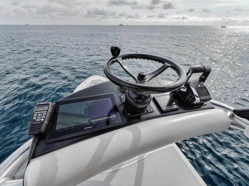 Slide: The Image of Helm of 2010 Bahama 41 boat with navigation equipment, steering wheel, and ocean view. - 34