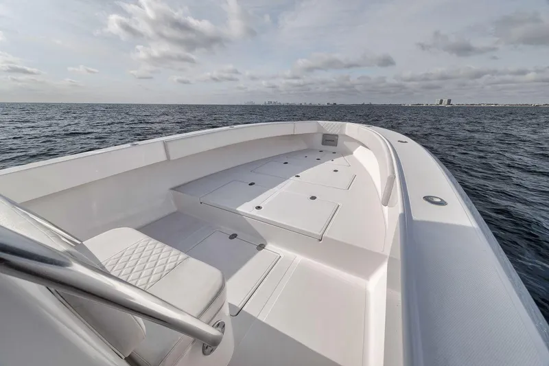 Slide: The Image of 2010 Bahama 41 boat on open water, featuring spacious deck and seating. - 43