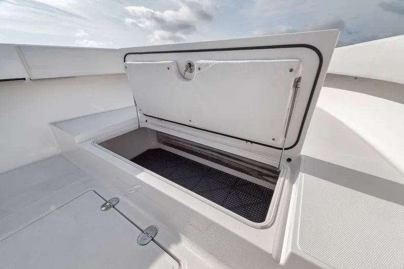 Slide: The Image of Open storage compartment on a 2010 Bahama 41 boat under a cloudy sky. - 44