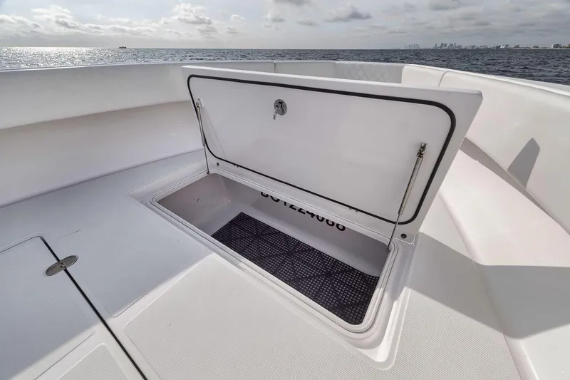 Slide: The Image of Open storage compartment on 2010 Bahama 41 boat, with ocean view in background. - 47