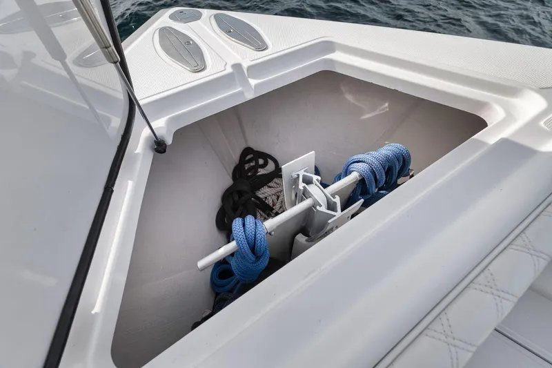 Slide: The Image of Anchor storage compartment on a 2010 Bahama 41 boat with ropes and anchor. - 49