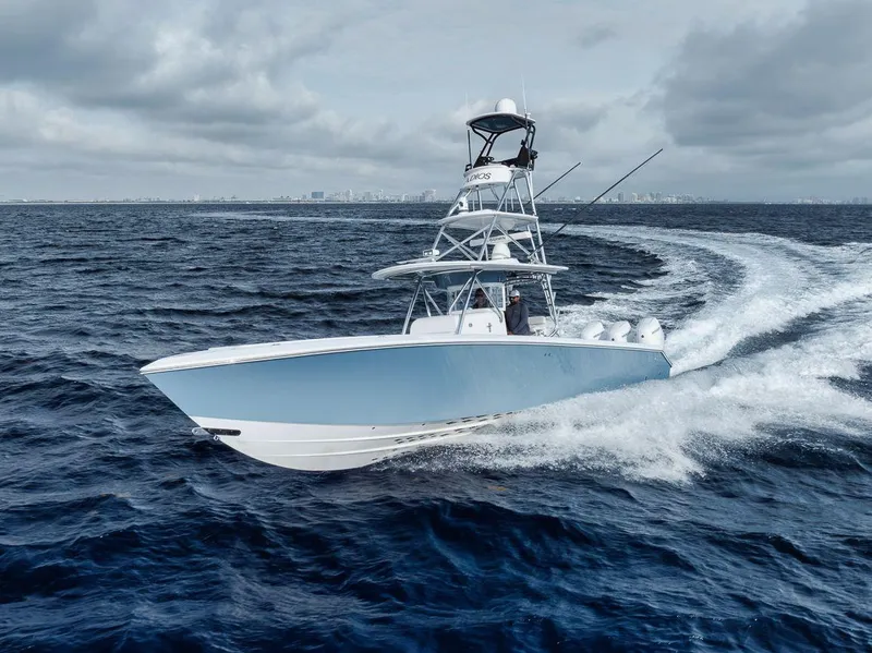 Slide: The Image of 2010 Bahama 41 boat cruising on open ocean under cloudy skies. - 5