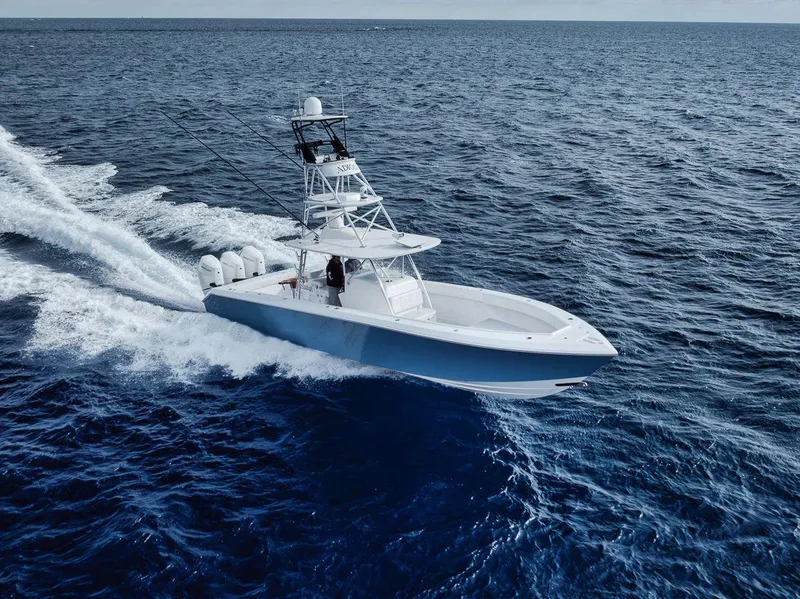 Slide: The Image of Bahama 41 boat cruising on open ocean, 2010 model, with multiple outboard engines. - 6