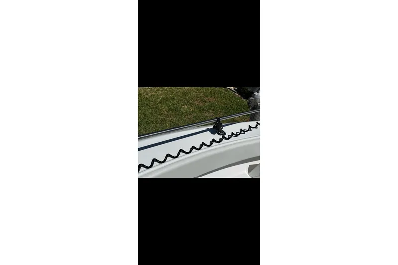 Slide: The Image of 2010 Bahama 41 boat railing with coiled cable, outdoor setting. - 85