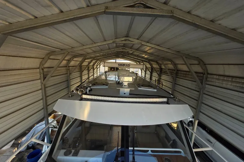 Slide: The Image of Custom Boat 34 (2025) under metal shelter, featuring advanced navigation equipment. - 10