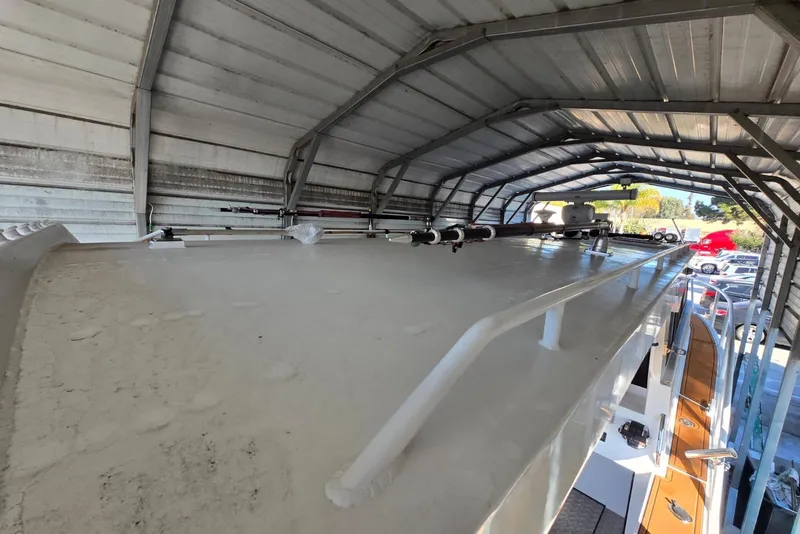 Slide: The Image of Custom Boat 34 (2025) under metal shelter, showcasing roof and equipment. - 12