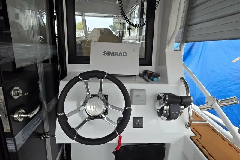Slide: The Image of Helm of 2025 Custom Boat 34 with Simrad navigation system and modern controls. - 19