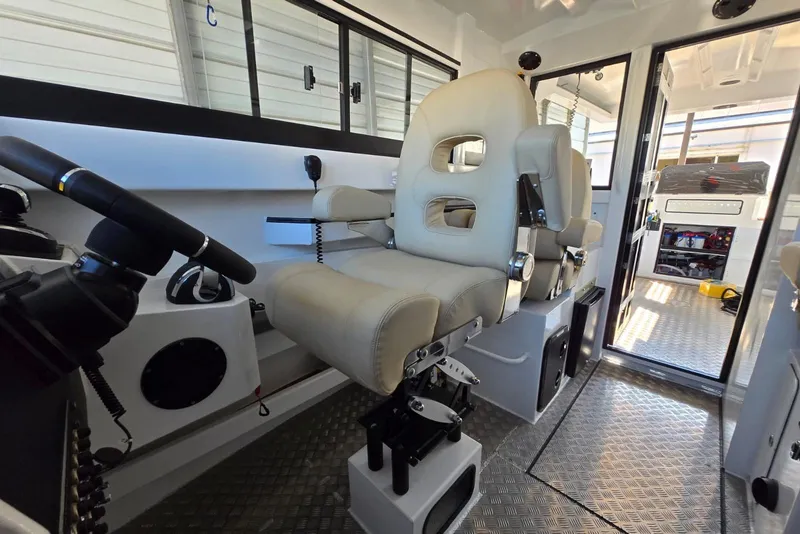 Slide: The Image of Interior of 2025 Custom Boat 34, featuring modern helm and comfortable seating. - 23