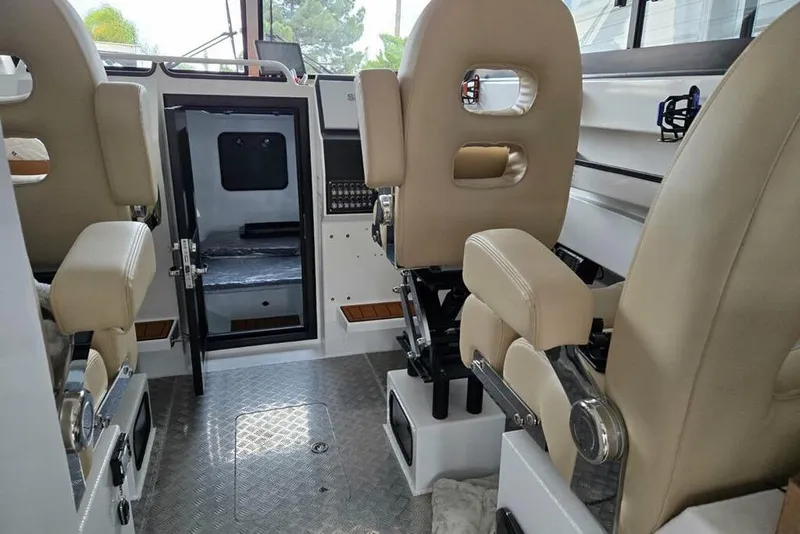 Slide: The Image of Interior of 2025 Custom Boat 34, featuring beige seats and modern design elements. - 24