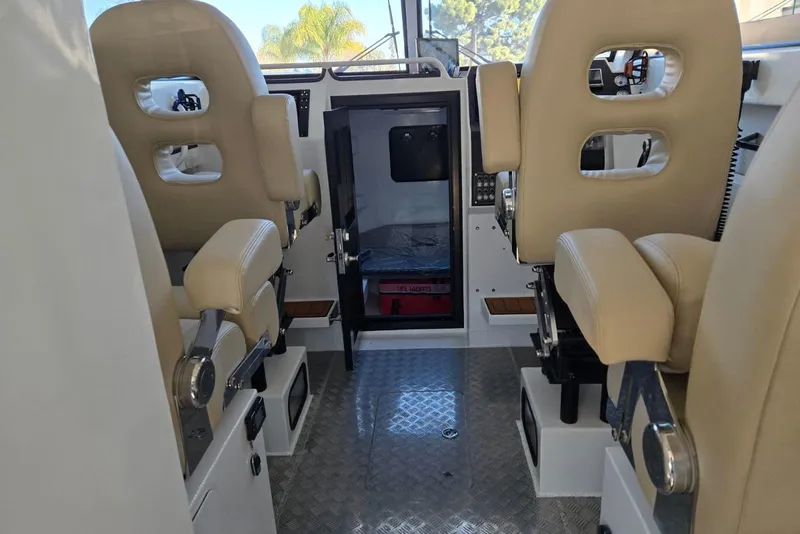 Slide: The Image of Interior of 2025 Custom Boat 34 with beige seats and modern controls. - 25