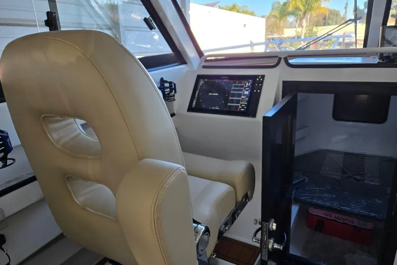 Slide: The Image of Interior of 2025 Custom Boat 34 with beige seating and modern navigation system. - 31