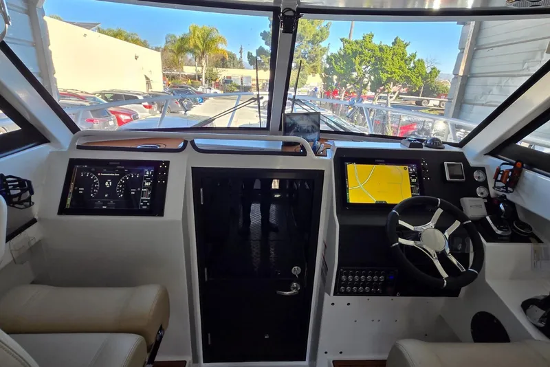 Slide: The Image of Interior cockpit of 2025 Custom Boat 34 with modern navigation displays. - 33