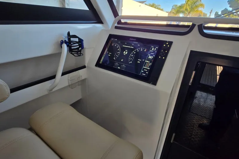Slide: The Image of Interior of 2025 Custom Boat 34 with advanced digital dashboard display. - 34