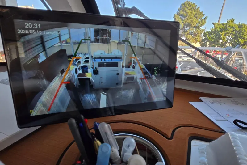 Slide: The Image of Tablet displaying boat camera feed inside a 2025 Custom Boat model 34 cockpit. - 38