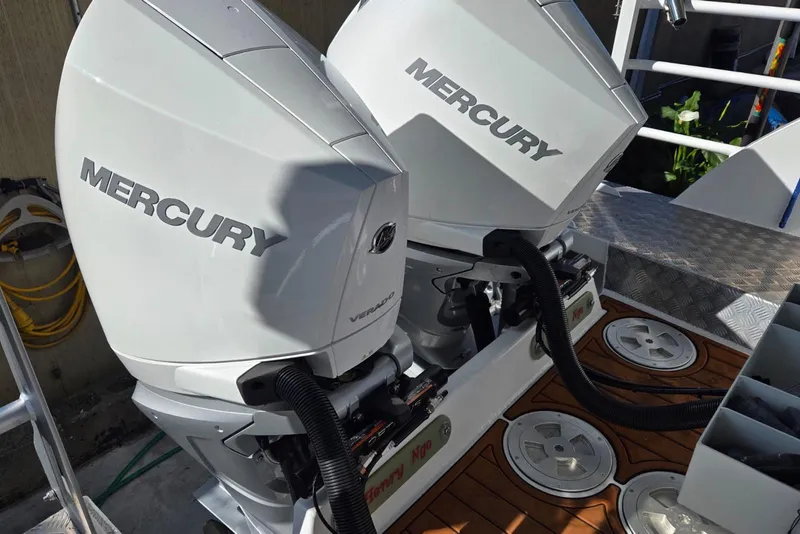 Slide: The Image of Twin Mercury outboard engines on a 2025 Custom Boat 34, featuring a sleek design. - 43